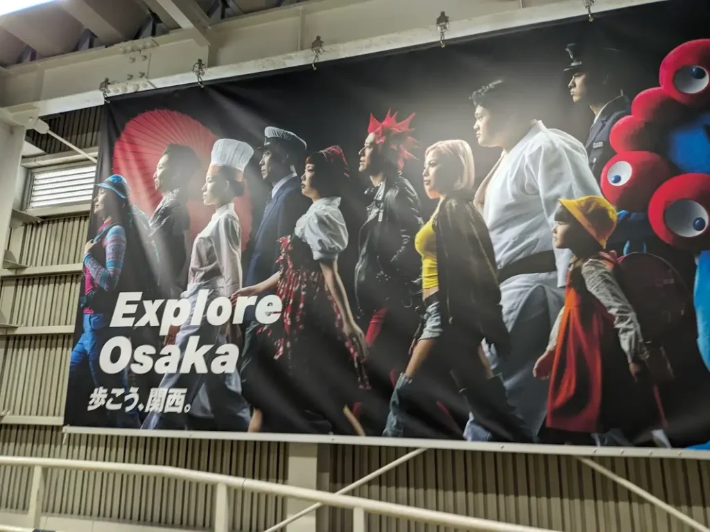 A poster for the Osaka Expo. The text reads "Explore Osaka."