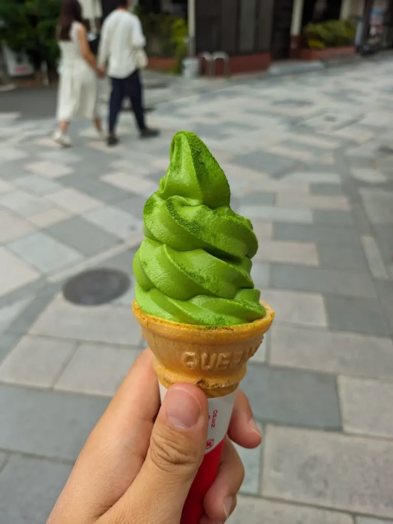 Me holding a matcha ice cream cone.