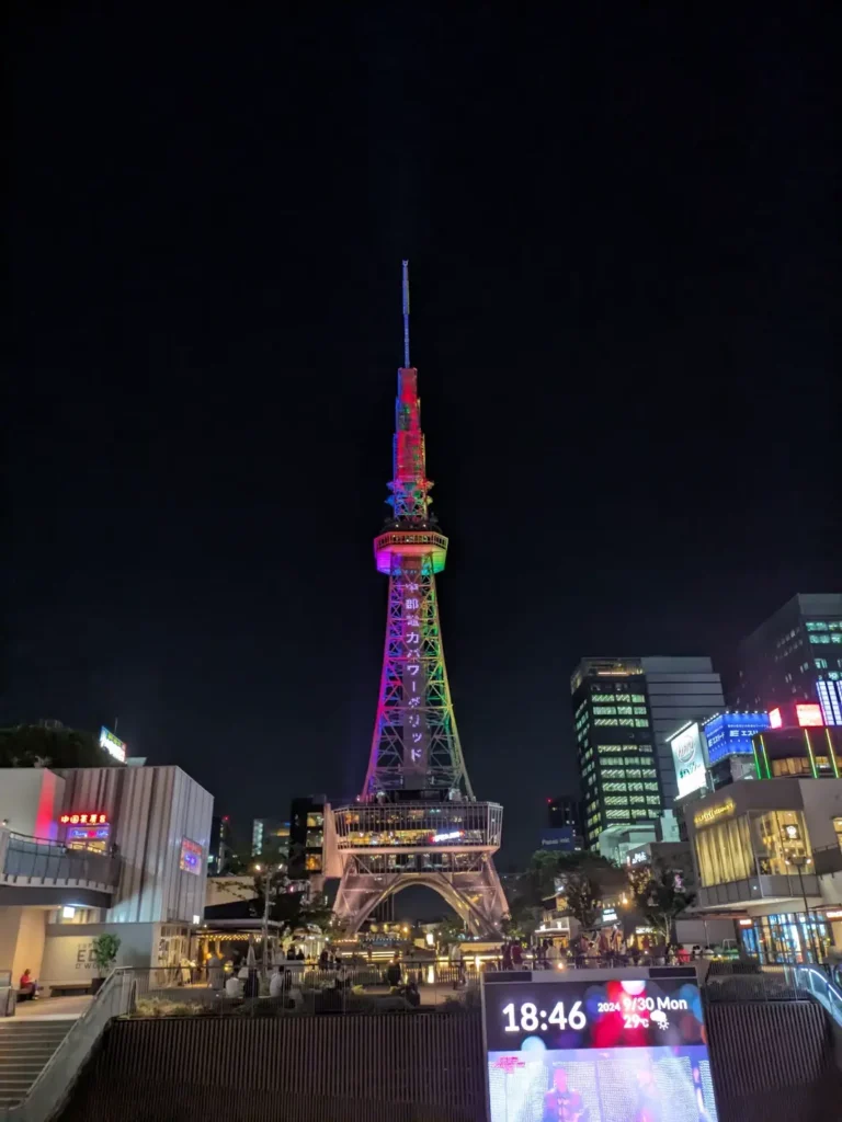 At night, the Mirai television tower glowing in rainbow colors.