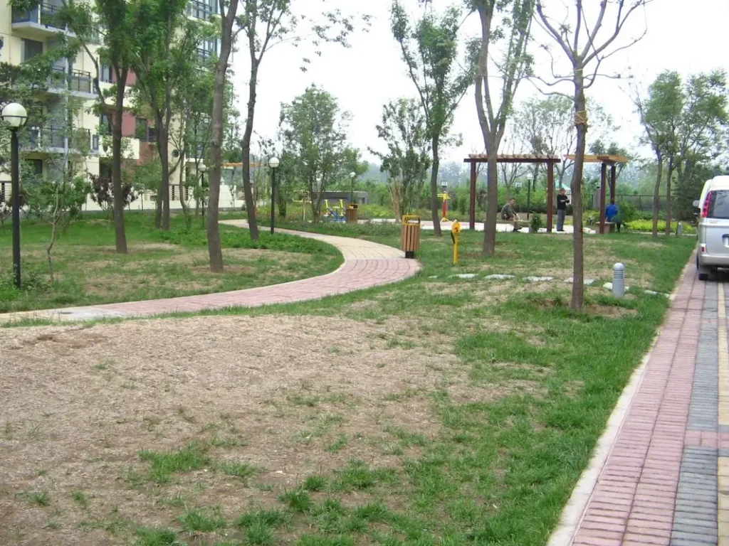 Grass under a pastel-color sky along with a building visible in the background.