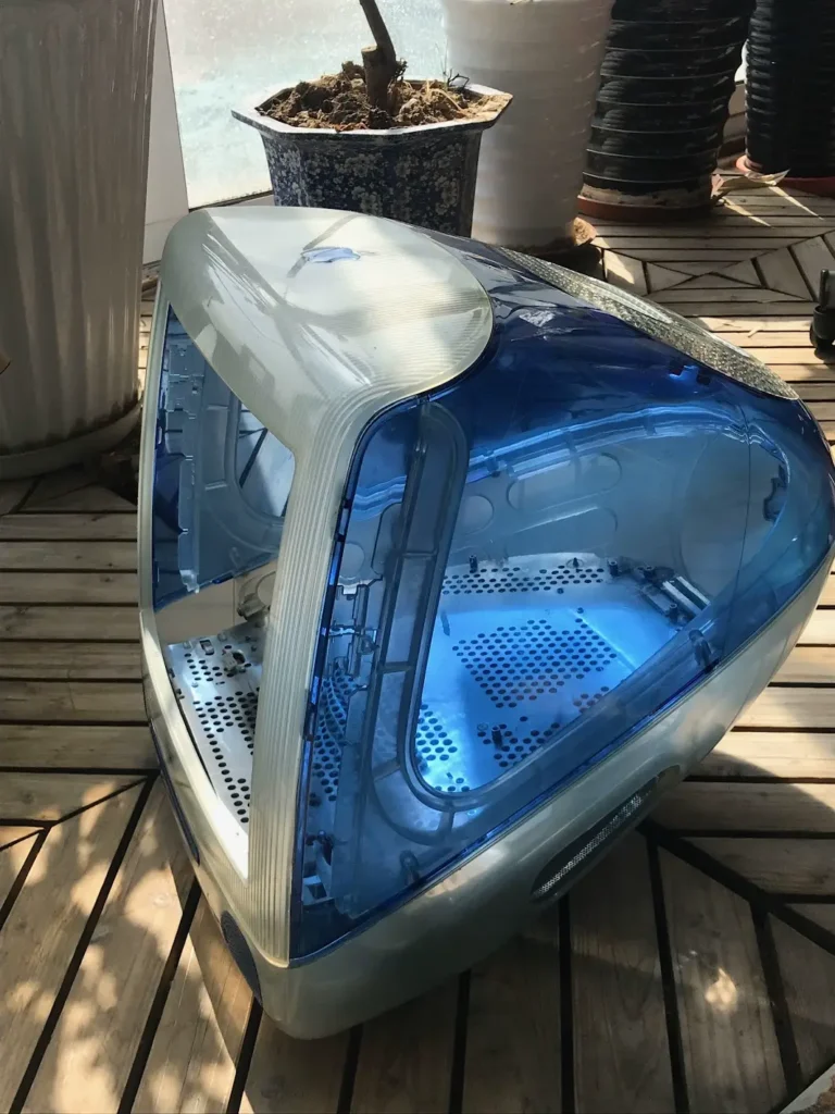 A shell of a chubby, blue iMac G3.