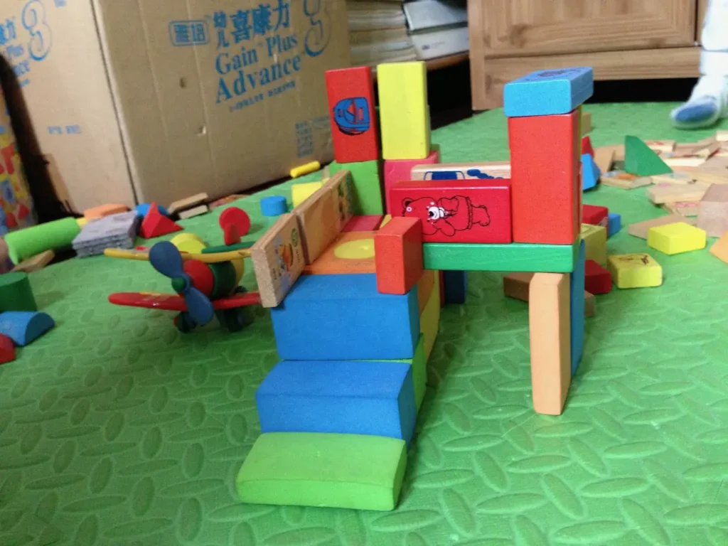 Several colorful toy blocks stacked on top of another.